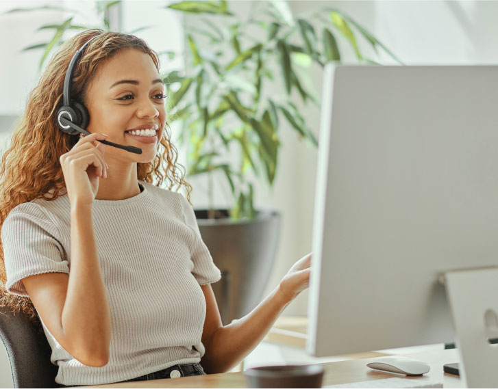 Friendly customer support representative wearing a headset helping someone